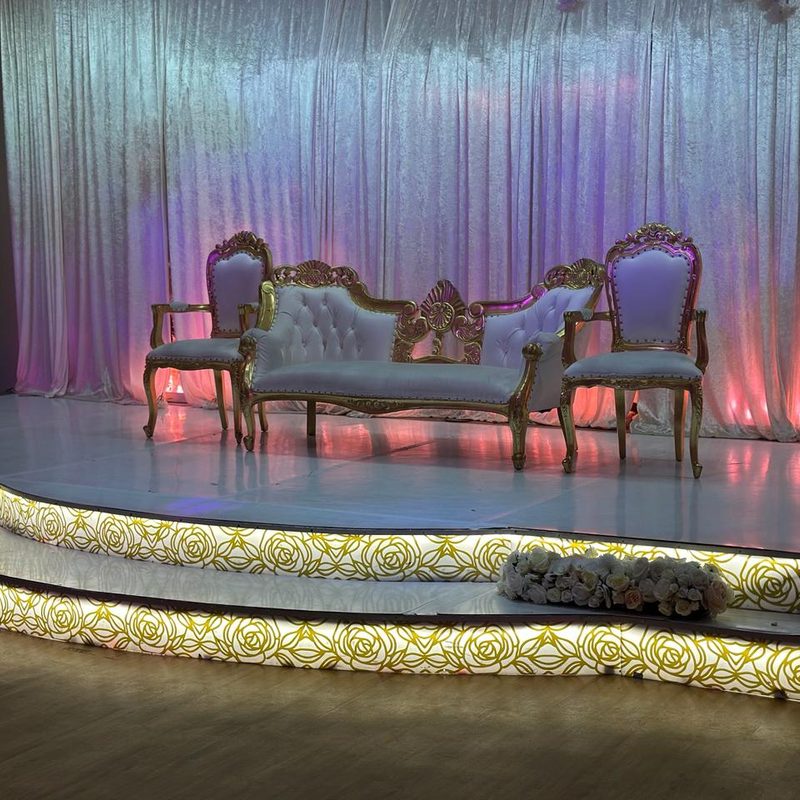 Ornate stage with white and gold throne chairs